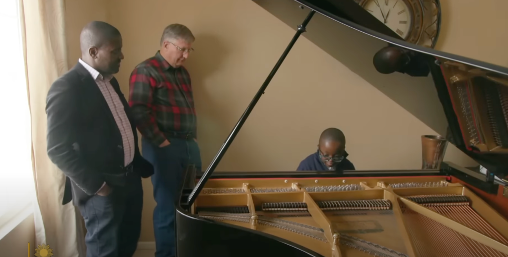 Jude Nyame Yie Kofie on a new piano.